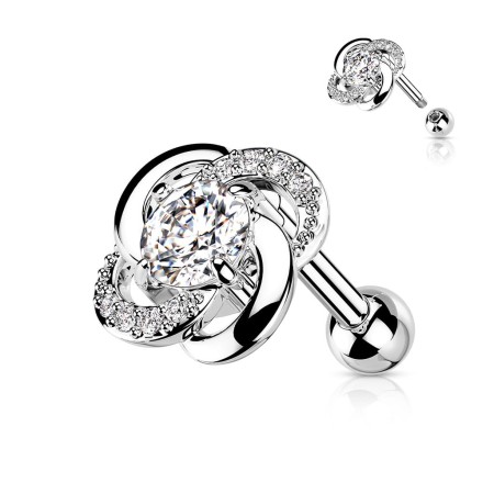 Sztanga Twisted Flower z kwiatkiem o średnicy 7,75 mm, ozdobiona białymi kryształkami i większym 3 mm kamieniem. Idealna do lobe, helix, conch i tragus. Wykonana ze stali chirurgicznej 316L i mosiądzu, Typ gwintu zewnętrzny.