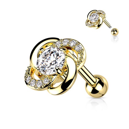 Sztanga Gold Twisted Flower z kwiatkiem o średnicy 7,75 mm, ozdobiona białymi kryształkami i większym 3 mm kamieniem. Idealna do lobe, helix, conch i tragus. Wykonana ze stali chirurgicznej 316L i mosiądzu z powłoką PVD. Typ gwintu zewnętrzny.