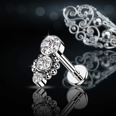 Labret  z trzema cyrkoniami i minimalistycznymi kuleczkami, długość nakrętki 9 mm. Idealny do lobe, helix, conch i tragus. Wykonany ze stali chirurgicznej 316L , z gwintem wewnętrznym.