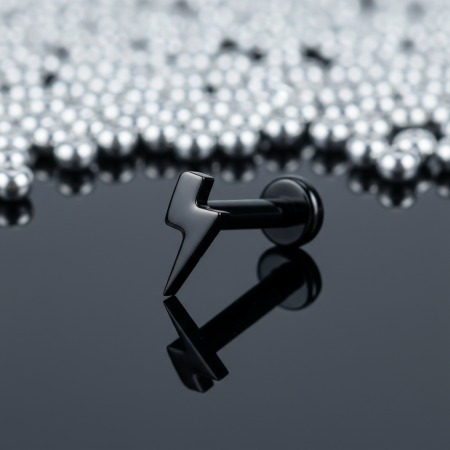 Tytanowy czarny labret z nakrętką w kształcie błyskawicy, idealny na świeże przekłucia i dla alergików.