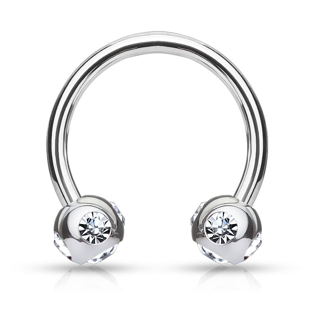 Podkówka z białymi kryształkami umieszczonymi pod i po bokach kuleczek. Wykonana ze stali chirurgicznej 316L. Idealna do septum, daith i smiley. Gwint zewnętrzny.