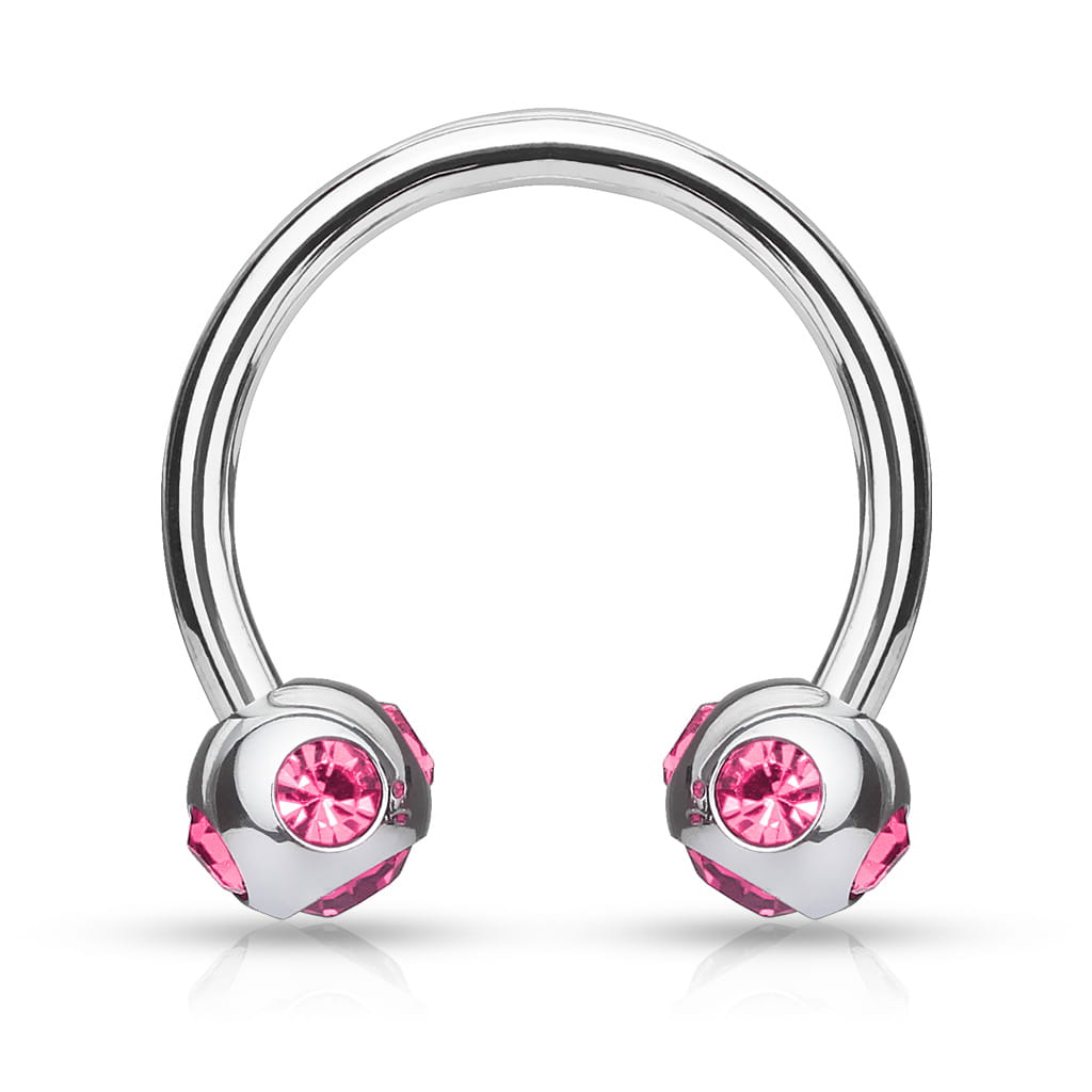 Podkówka z różowymi kryształkami umieszczonymi pod i po bokach kuleczek. Wykonana ze stali chirurgicznej 316L. Idealna do septum, daith i smiley. Gwint zewnętrzny.