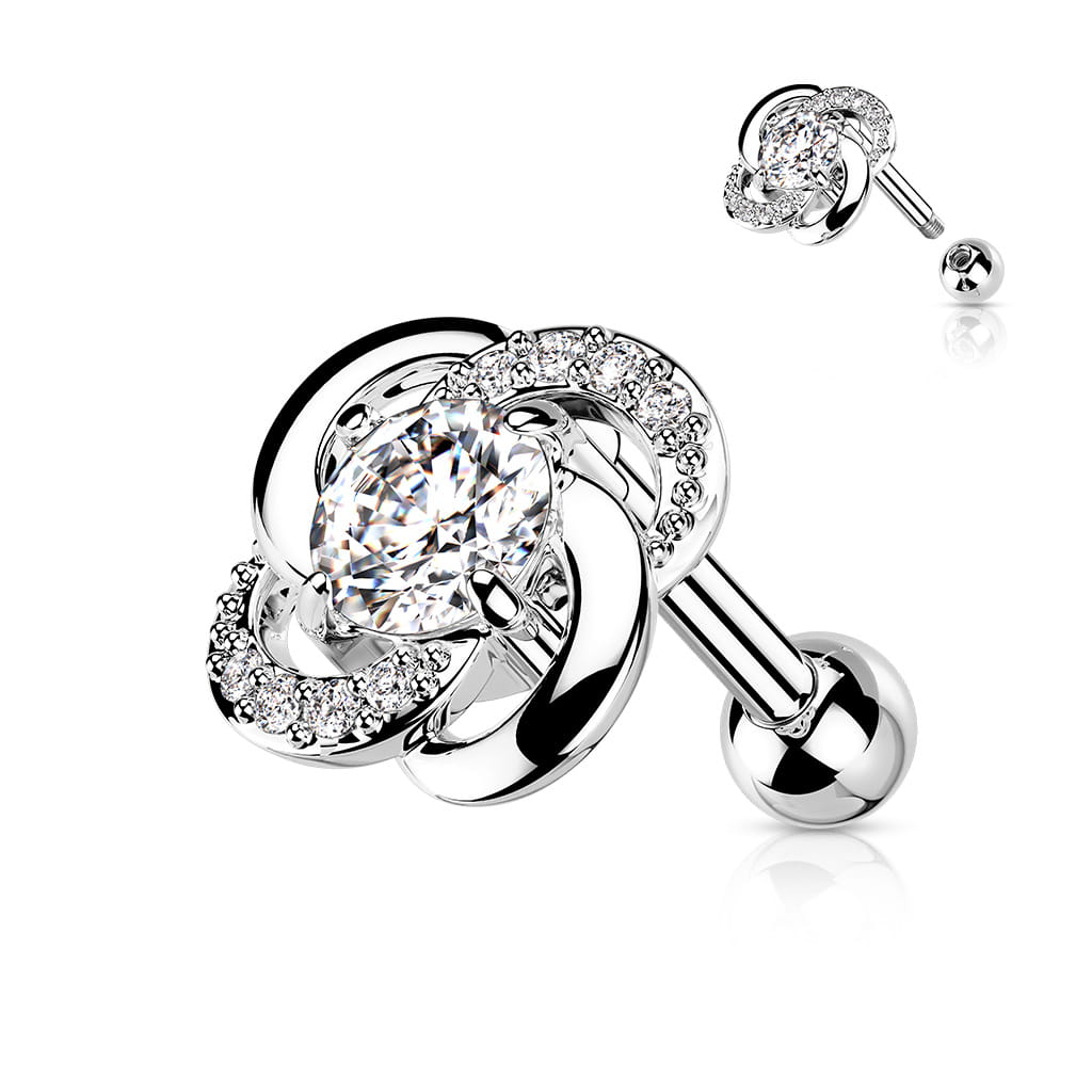 Sztanga Twisted Flower z kwiatkiem o średnicy 7,75 mm, ozdobiona białymi kryształkami i większym 3 mm kamieniem. Idealna do lobe, helix, conch i tragus. Wykonana ze stali chirurgicznej 316L i mosiądzu, Typ gwintu zewnętrzny.