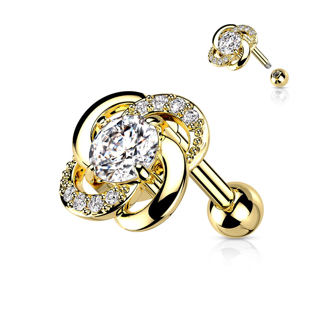 Sztanga Gold Twisted Flower z kwiatkiem o średnicy 7,75 mm, ozdobiona białymi kryształkami i większym 3 mm kamieniem. Idealna do lobe, helix, conch i tragus. Wykonana ze stali chirurgicznej 316L i mosiądzu z powłoką PVD. Typ gwintu zewnętrzny.
